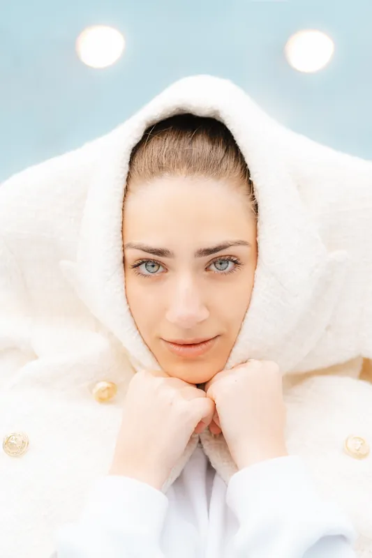 Model test, look one: cream jacket worn as a hood, soft light