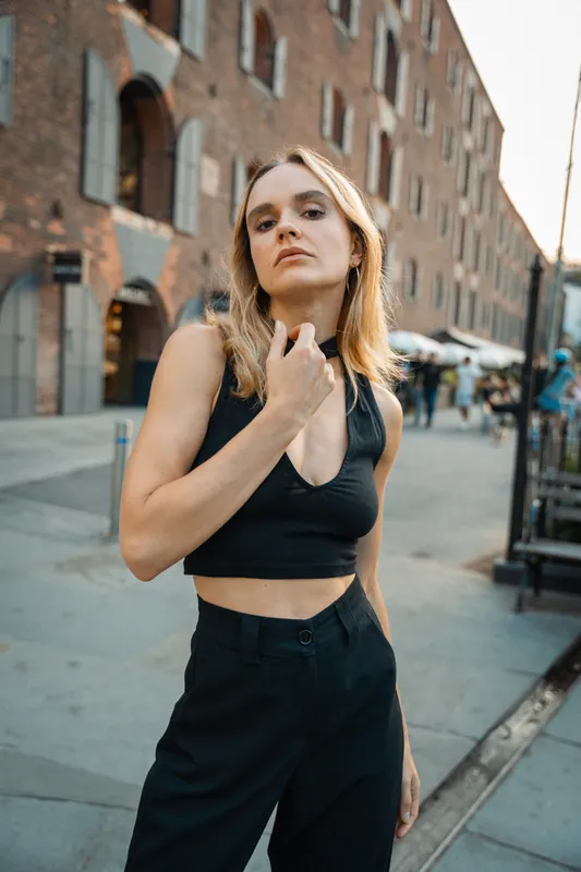 Black crop top and trousers on a DUMBO cobblestone street
