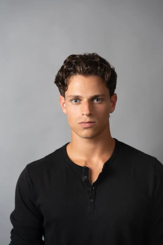 Black henley, waist-up, grey studio backdrop