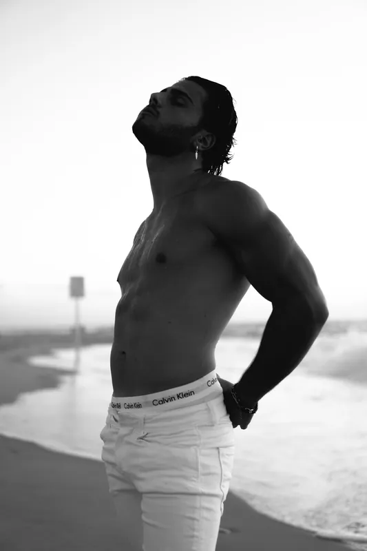 Black and white profile in white jeans at the water's edge