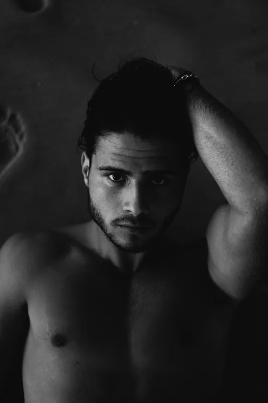 Low key black and white portrait, hand in hair