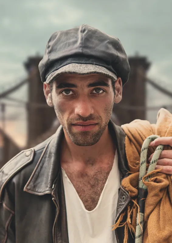 Man in a newsboy cap and leather jacket, DUMBO