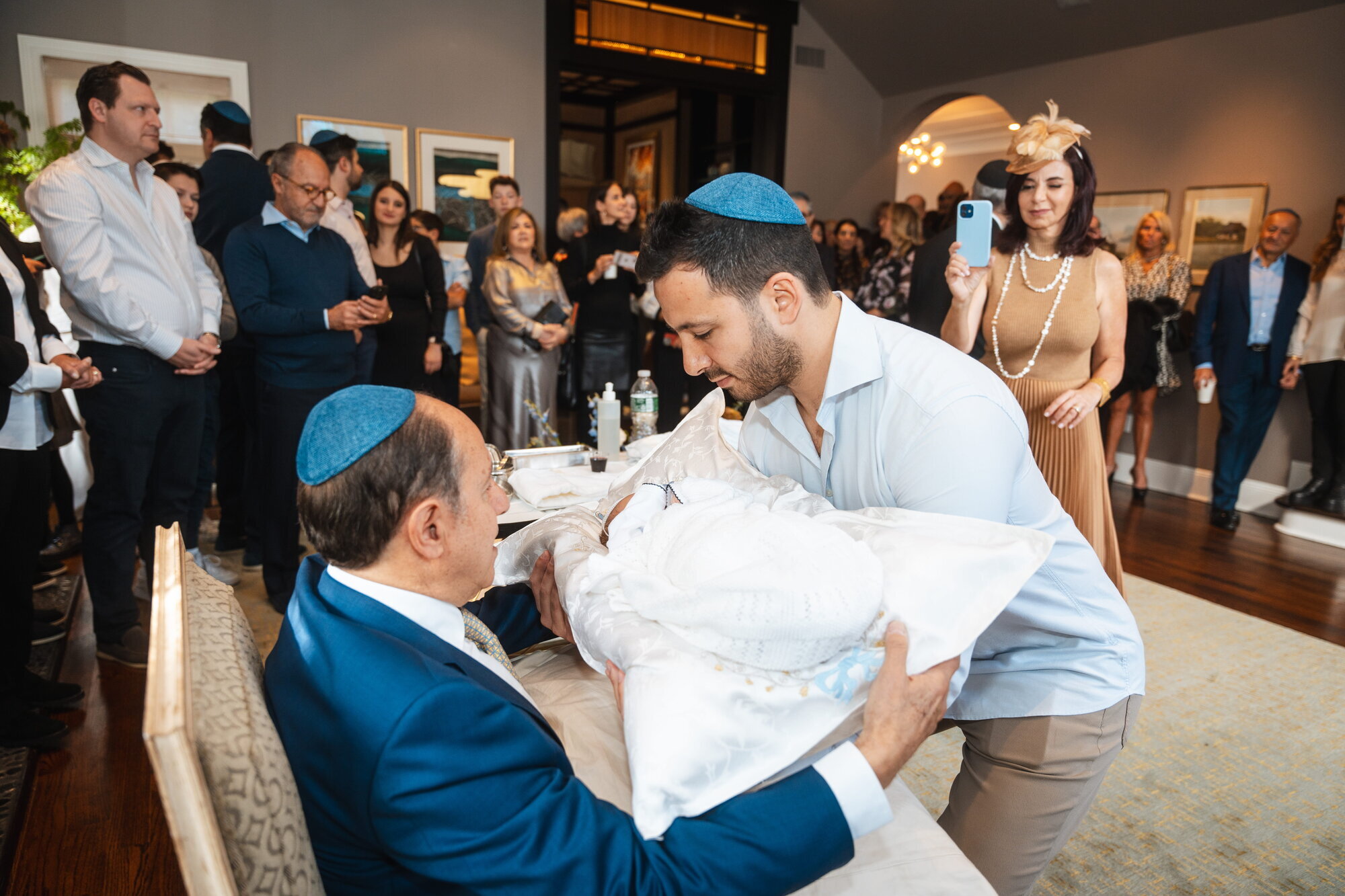 Guests gathered close during a bris ceremony