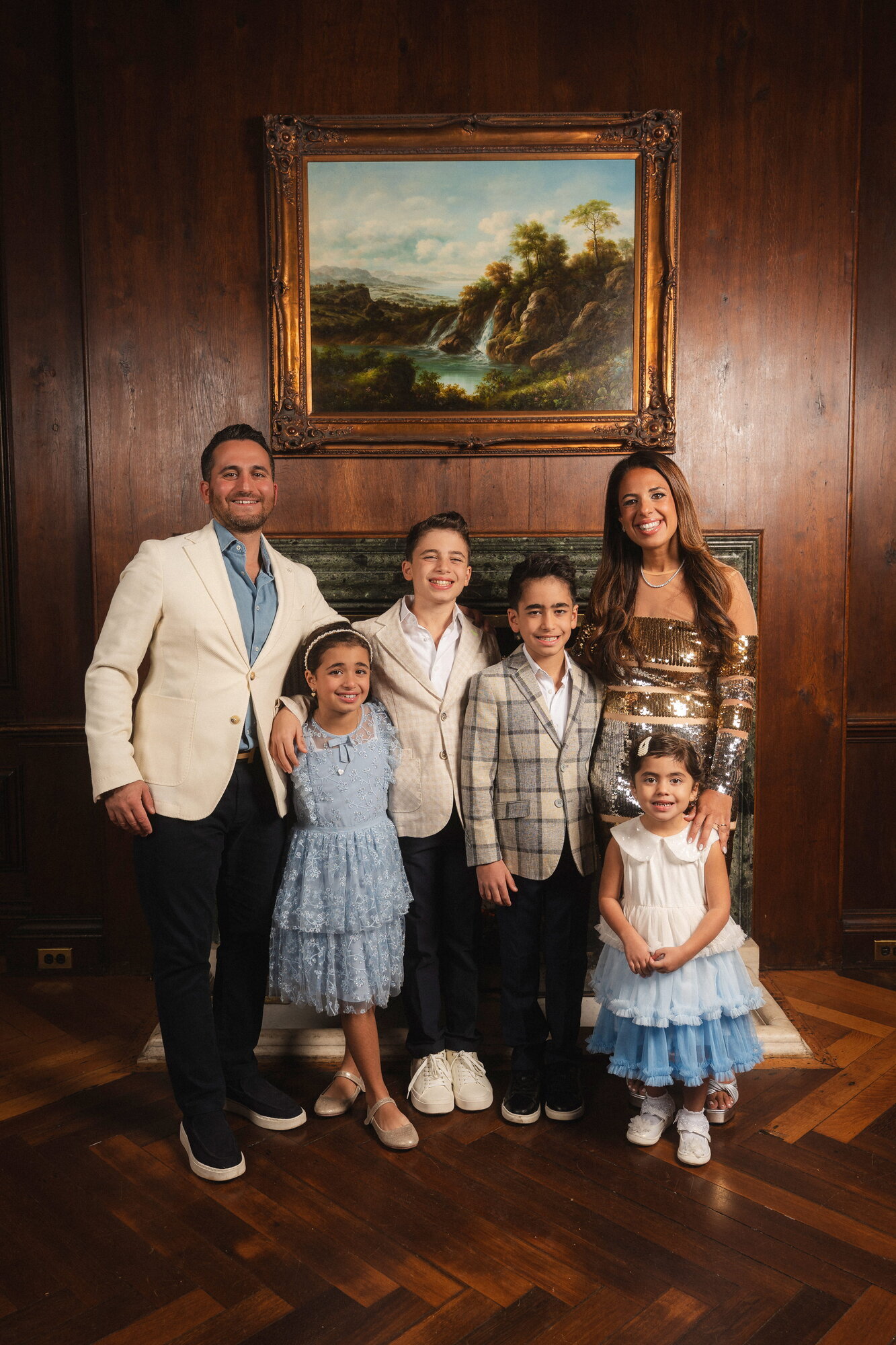 Family portrait in a wood paneled room at a bar mitzvah celebration